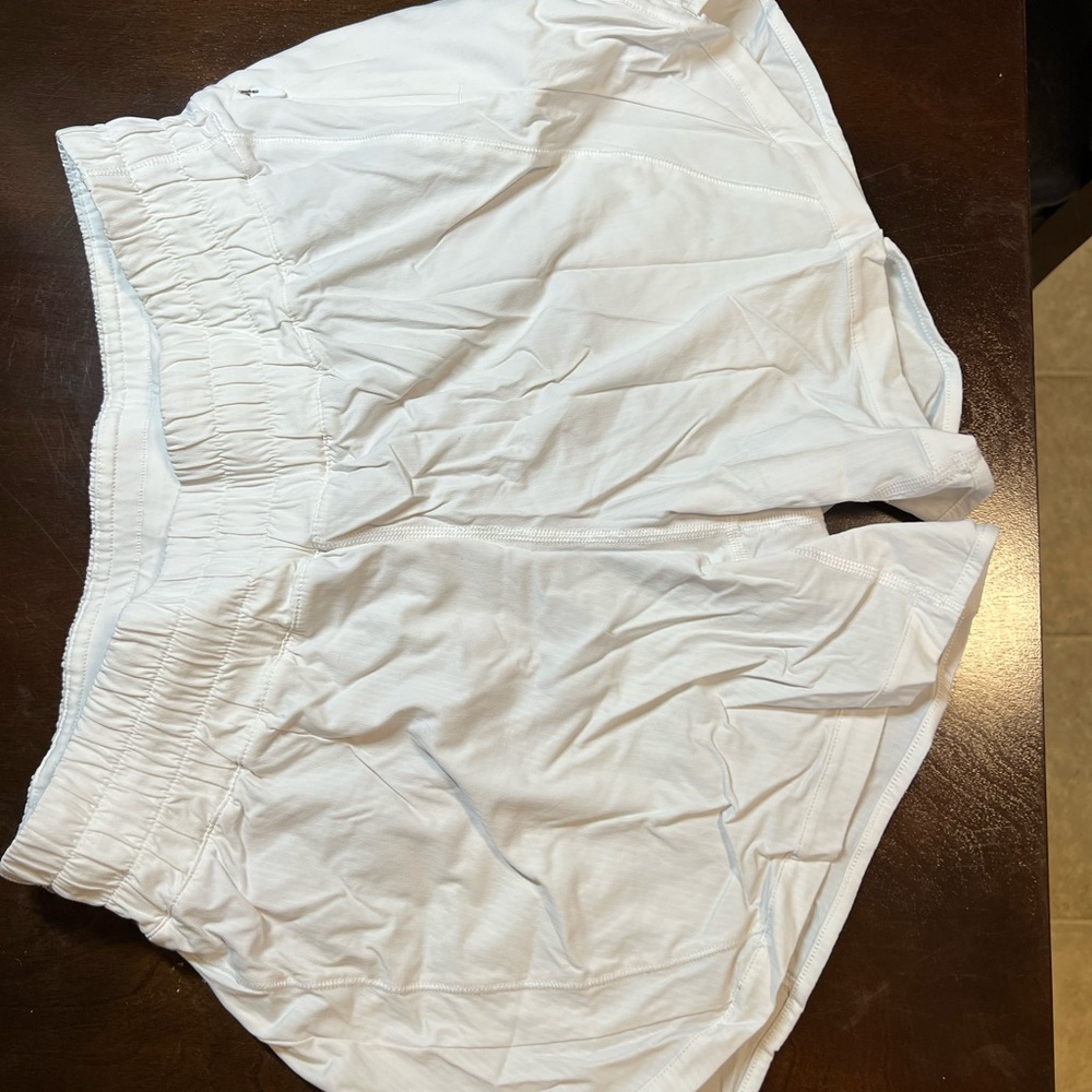 White Lululemon track that mid rise shorts, worn once, lined, size 8, 5” inseam